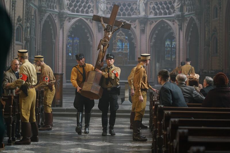 Bonhoeffer film still: Nazi stormtroopers march through a cathedral